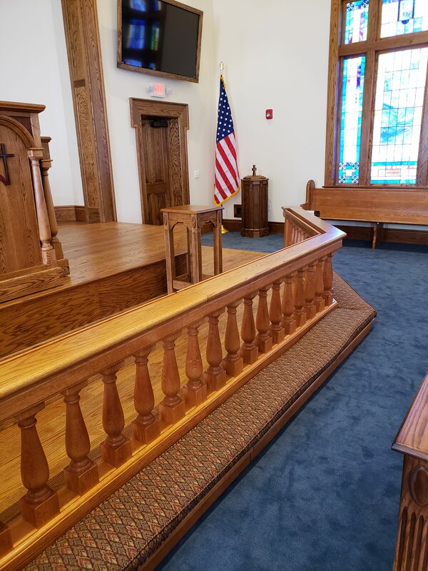 view of wooden detailing and kneeling bench for offering at St. Luke UMC