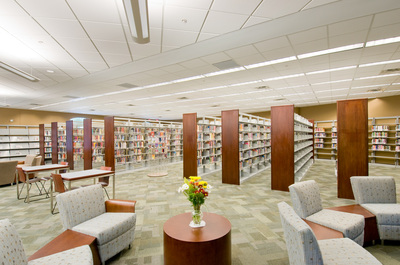 side view of shelving with books and sitting area of Nancy Guinn Memorial Library 