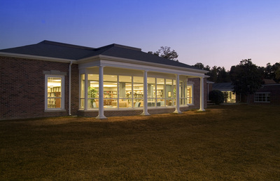exterior of Augusta Preparatory Day School library lit up at dusk 