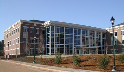 front exterior of brick building with large front glass atrium of University Hall at Augusta University 