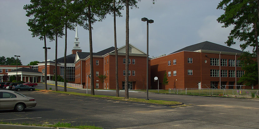 Warren Baptist Church Augusta campus with playground and family life building in center behind trees