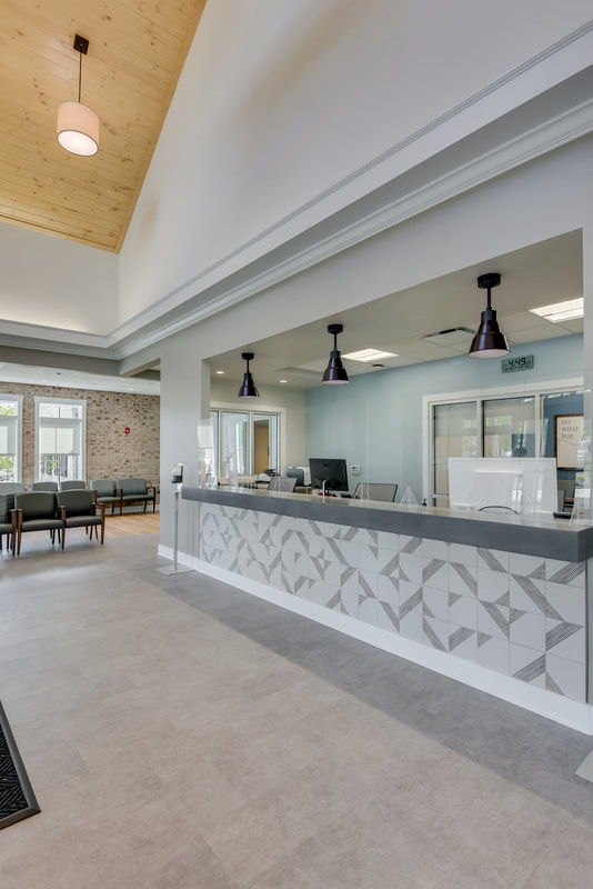 grey tonal geometric tiling of front reception desk of Evans Medical Group 
