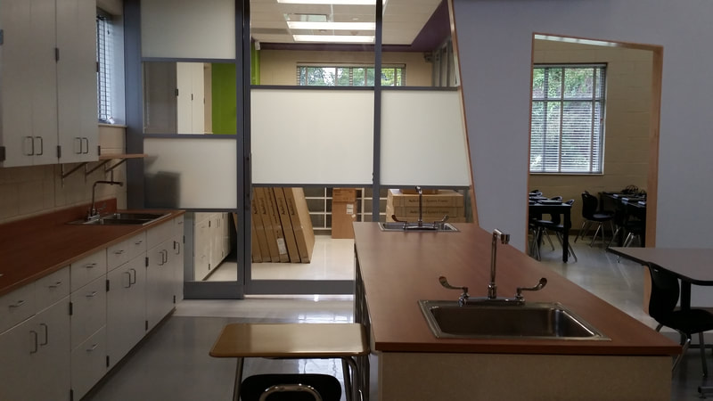 side view of teacher's lab station and teaching area looking into glass storage area
