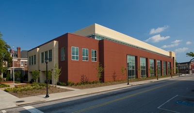 side exterior view of Augusta-Richmond County Public Library done in red brick with stucco and tall rectangular windows