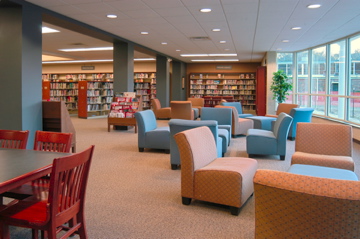interior of Augusta Preparatory Day School library seating area with orange and blue chairs