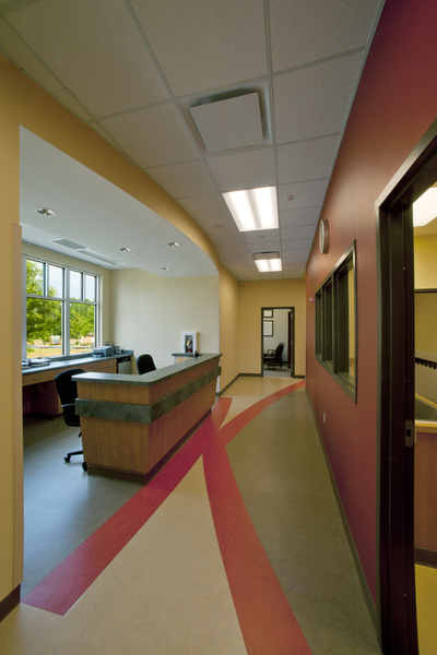 nurse's station inside of Pediatric Partners of Augusta with red and grey geometric flooring and large open windows in background 