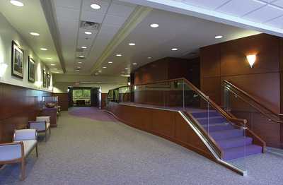 interior hallway with wood paneling and a purple staircase inside Canter Medical Services Building 