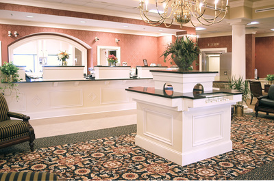 teller counter and richly patterned carpet of First Bank of Augusta