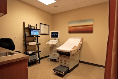 exam room in Women's Health of Augusta office with large graphic landscape painting on wall