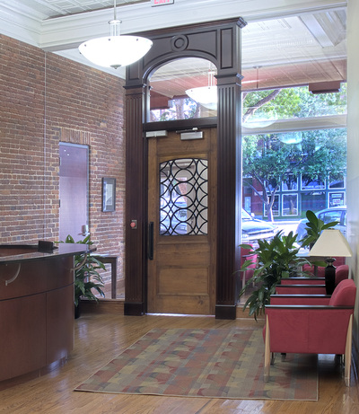 wooden entrance door surrounded by glass windows of R.W. Allen corporate offices