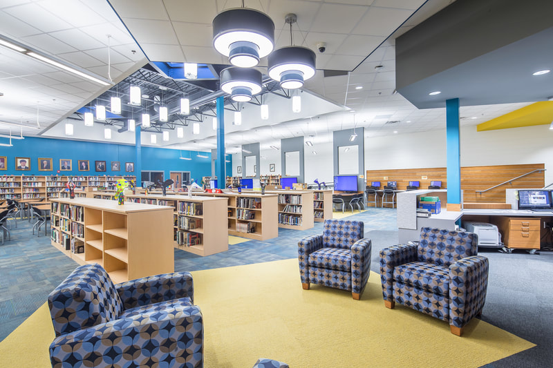geometric patterned chairs in Butler High School media center and library next to low book shelving 