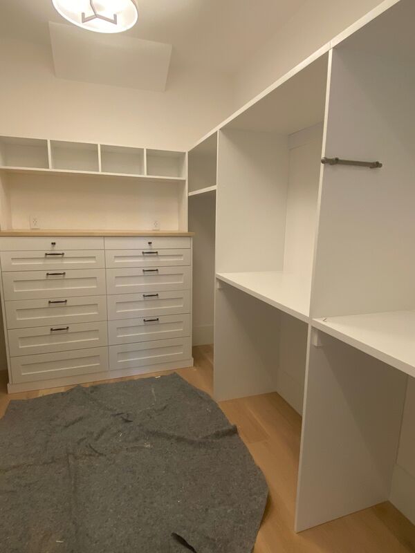 large master walk-in closet with drawers and open shelving