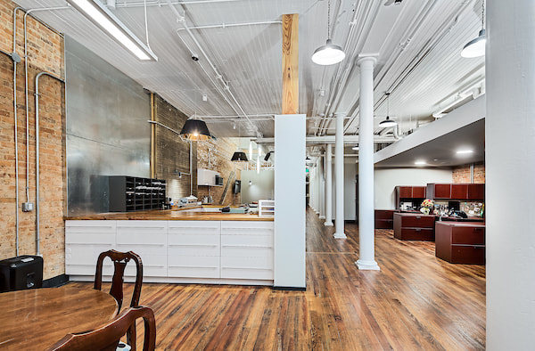 Destination Augusta offices done with rich wooden desks, white wooden accents, and bright lighting 