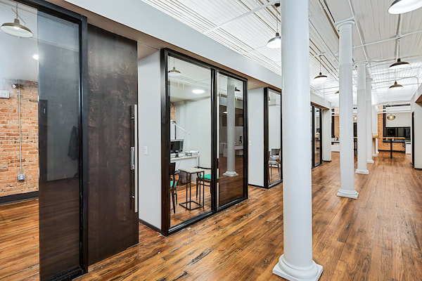 view into windowed offices separated by decorative columns 
