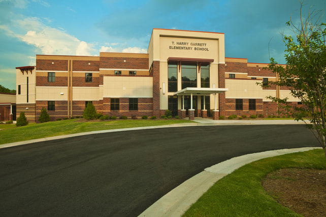 The new T. Harry Garrett Elementary School was designed to be reminiscent of the Grand Canyon with multicolored brick exterior and painted river features on the interior. 