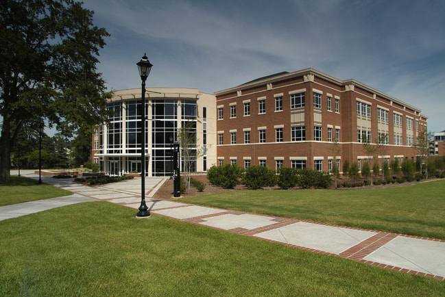 Exterior of Augusta University University Hall multistory brick building with glass atrium