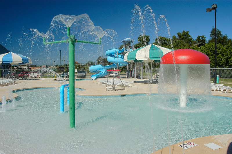 colorful splash pad and spray ground with whimsical design elements at Augusta Family Y 