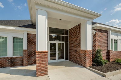 Front entrance of Augusta Endoscopy Center with glass doors and paneling under a pillared canopy 