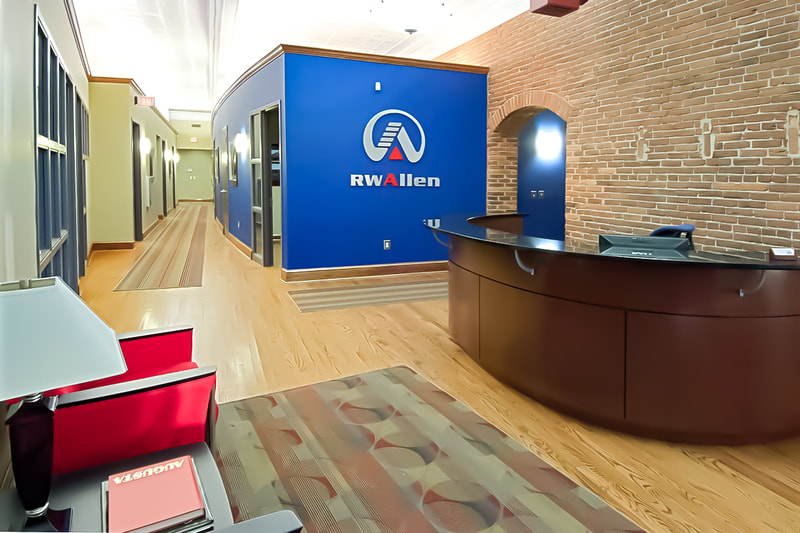 R.W. Allen corporate offices front office with blue accent wall and wooden reception desk 