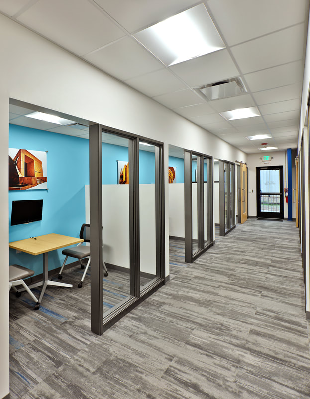 hall view of meeting rooms with blue accent wall at MAU workforce solutions in Greenville