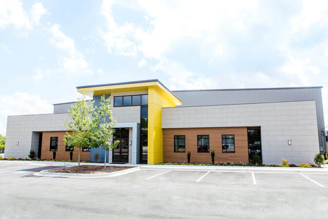 Front entrance of Augusta Data Storage building with geometric design and yellow accents